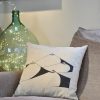 bodyscape beige cotton square cushion made of 100% cotton, with abstract design of a woman's chest on a sofa.