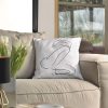 ffabula white cushion made of 100% cotton, with print female body design, decorates beige sofa.