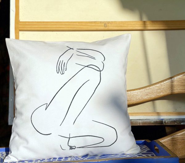 fabula white cushion made of 100% cotton, with printed female body design, close-up.