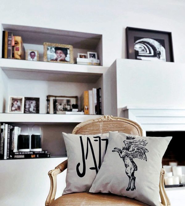jazz beige cushion made of 100% cotton, with a wonderful print of the word jazz on a classic fabric armchair along with another cushion.