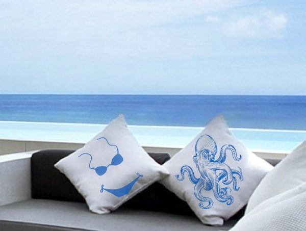 antonio White cushion made of 100% cotton, and blue octopus design decorates the exterior of a summer house in front of the sea.