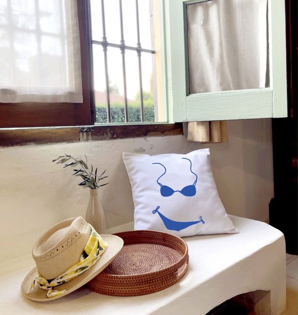blue bikini White cushion made of 100% cotton, with blue bikini print, decorates the exterior of a summer house.