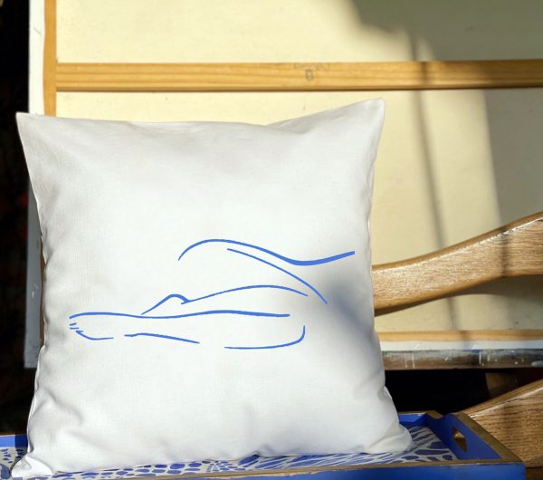 blue muse White cushion made of 100% cotton, blue female body contour design indoors.